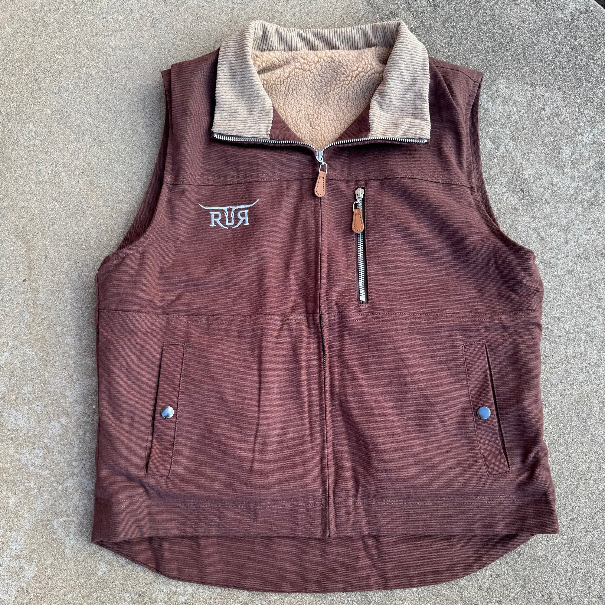 Brown jacket with fur lining on a concrete surface