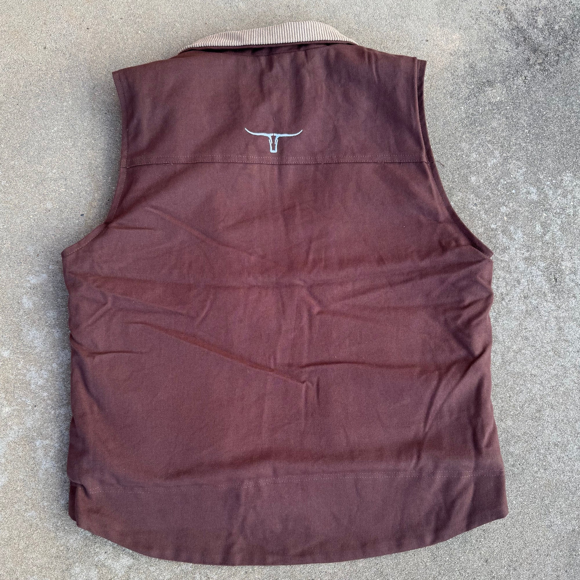 Brown sleeveless top on a concrete surface