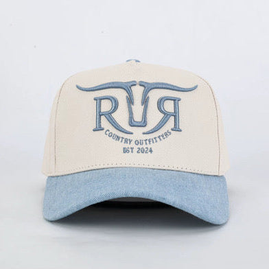 A structured baseball cap with an off-white crown and a light blue denim-look brim, featuring a blue embroidered logo on the front that reads 'RR Country Outfitters EST 2024'.