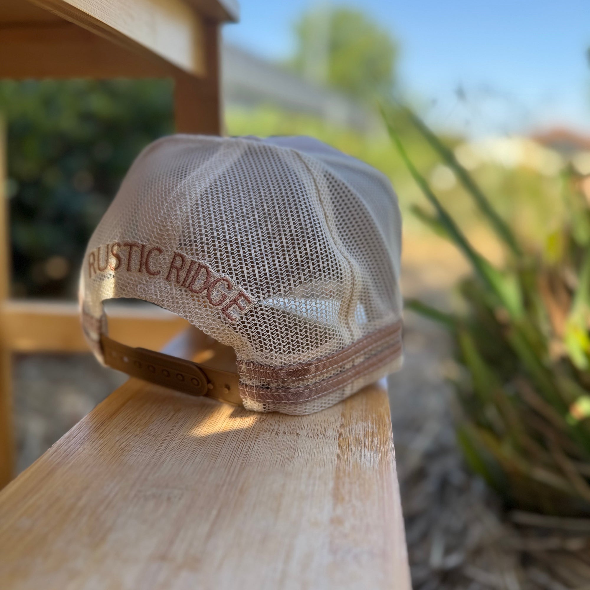Cap with 'Rustic Ridge' logo on a wooden surface outdoors