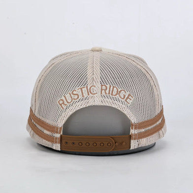 Rustic Ridge trucker hat shown from the back, featuring a beige mesh back, brown leather strap, and brown embroidered logo text.