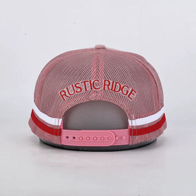 A pink mesh-back trucker cap shown from the back, featuring 'RUSTIC RIDGE' embroidered in pink across the top and a red and white stripe detail on the back band.