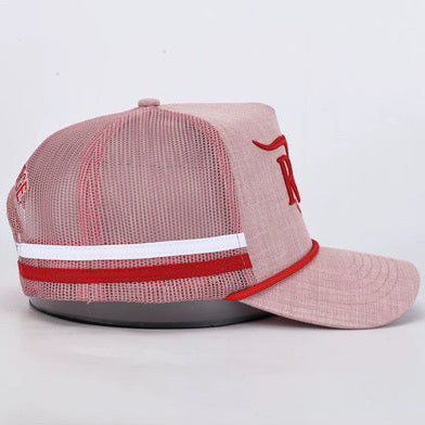 A light pink trucker-style baseball cap with a mesh back, a white horizontal stripe with a red center stripe near the brim, and a red embroidered logo on the front panel, displayed on a gray stand against a white background.